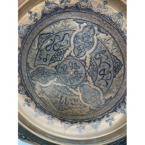 506 - PERSIAN METALWARE SHALLOW BOWL ENGRAVED WITH ARABESQUES AND SCRIPTS, AND AN INDIAN ENGRAVED BRASS SM... 