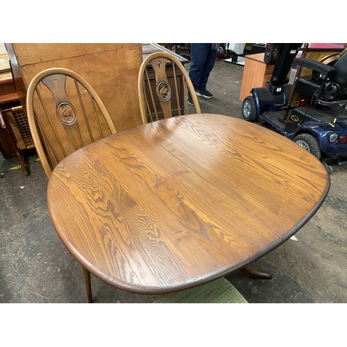 31 - ERCOL EXTENDING DINING TABLE WITH FOUR SWAN CAMEO BACK CHAIRS