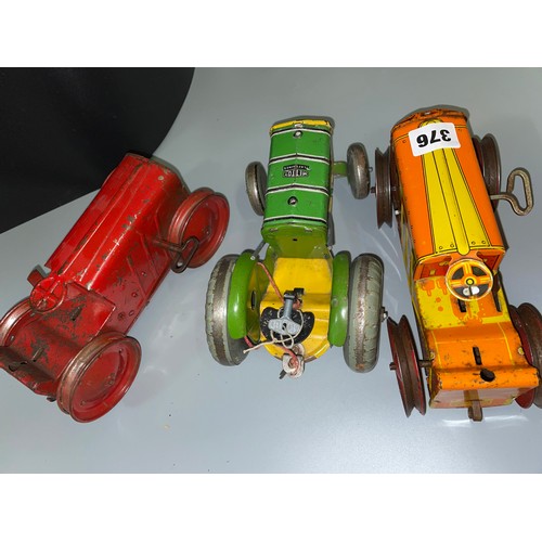 376 - METTOY PLAYTHINGS C1950 GREEN TIN PLATE CLOCKWORK TRACTOR WITH KEY AND TWO LITHOGRAPHED CLOCKWORK C1... 