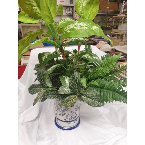 381 - BLUE AND WHITE TAPERED VASE OF ARTIFICIAL PLANT FOLIAGES