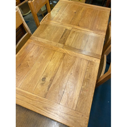 47 - OAK EXTENDING DINING TABLE WITH FOUR LADDER BACK CHAIRS