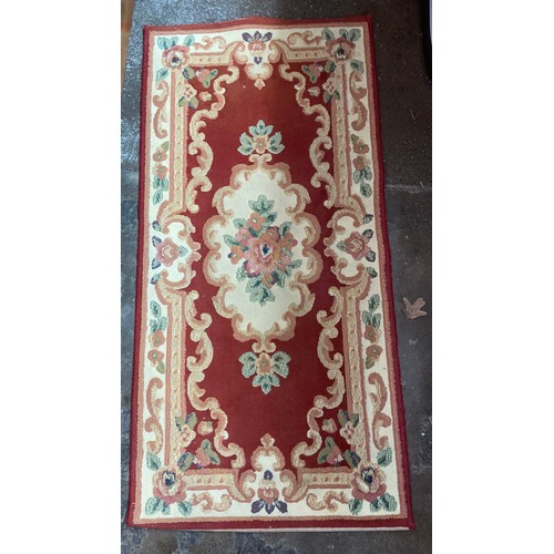 TWO RED GROUND FRINGE CARPET RUNNERS