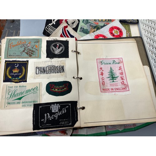 486 - ALBUM OF SILK CLOTHING LABELS AND BADGES AND VARIOUS OTHER SILKS MAINLY LATE 1940S/50S AND REPS COLO... 