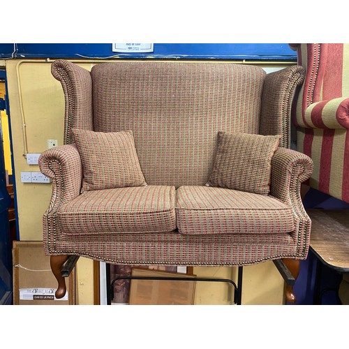 72 - RED AND BROWN CHEQUERED HIGH WING BACK TWO SEATER SOFA ON CABRIOLE LEGS