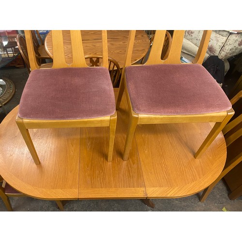 76 - PARKER KNOLL TEAK CROSS BANDED DROP FLAP DINING TABLE AND FOUR CHAIRS