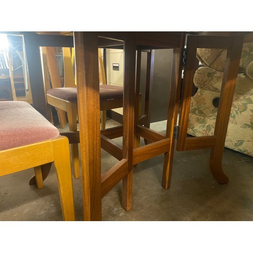 76 - PARKER KNOLL TEAK CROSS BANDED DROP FLAP DINING TABLE AND FOUR CHAIRS