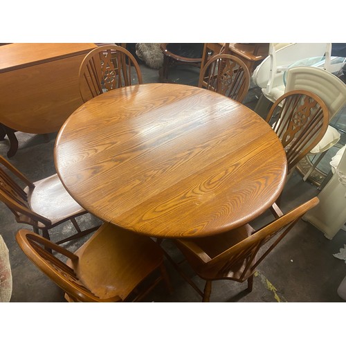 41 - ERCOL ELM DROP FLAP TABLE WITH SIX MATCHED WHEEL BACK DINING CHAIRS