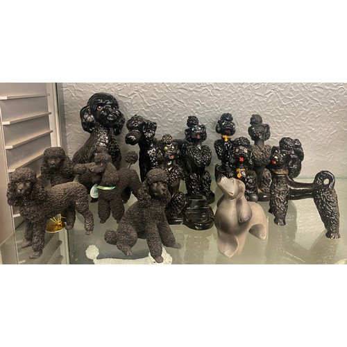 215 - HALF SHELF OF BLACK POODLE FIGURES