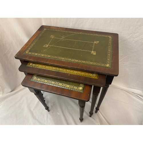 45 - NEST OF THREE MAHOGANY GREEN LEATHER TOPPED TABLES