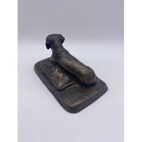 411 - MARY RINSENL BRONZED RECUMBENT DASCHUND ON CUSHION 8CM H