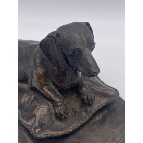 411 - MARY RINSENL BRONZED RECUMBENT DASCHUND ON CUSHION 8CM H