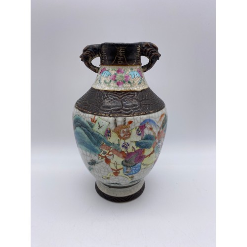 364 - CHINESE CRACKLE GLAZE TWIN HANDLE VASE WITH WARRIORS IN BATTLE 20CM H