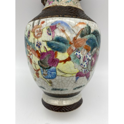 364 - CHINESE CRACKLE GLAZE TWIN HANDLE VASE WITH WARRIORS IN BATTLE 20CM H