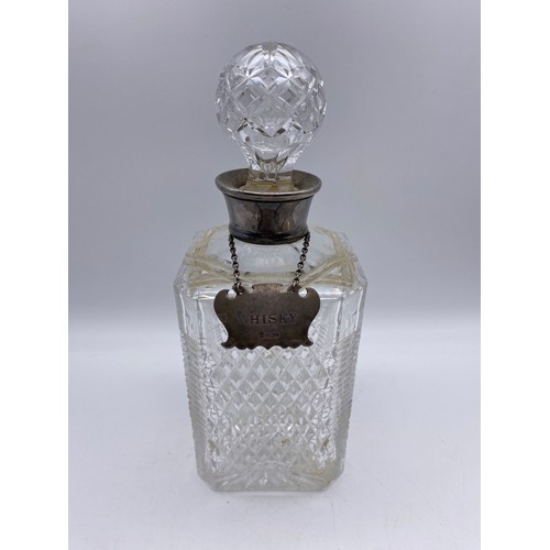 403 - FOUR CUT GLASS DECANTERS, ONE WITH SILVER WHISKY SPIRIT LABEL