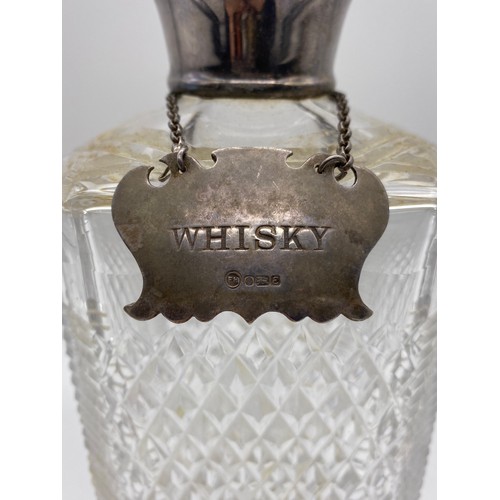 403 - FOUR CUT GLASS DECANTERS, ONE WITH SILVER WHISKY SPIRIT LABEL