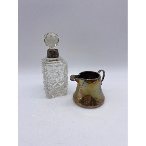 385 - BIRMINGHAM SILVER MINIATURE CREAMER 1.4OZ APPROX AND A SILVER TOPPED GLASS SCENT BOTTLE