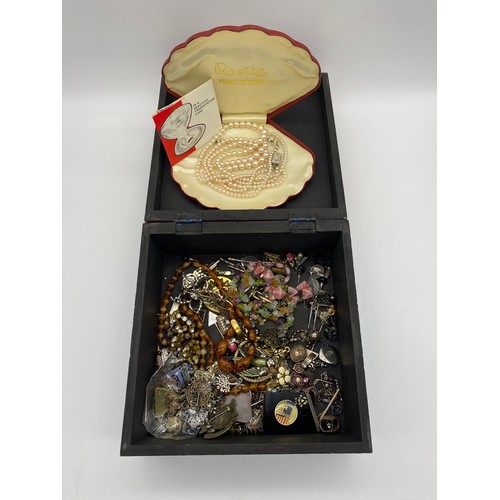 429 - WOODEN BOX OF VARIOUS COSTUME JEWELLERY AND ROSITA SIMULATED PEARL NECKLACES, BADGES, SILVER CHARMS ... 