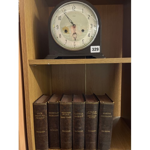 329 - BROWN BAKELITE CASED ENFIELD MANTLE CLOCK AND SIX NOVELS BY DICKENS