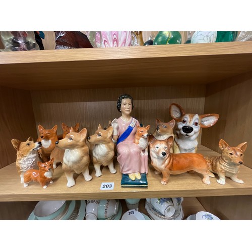 203 - SHELF OF CERAMIC CORGI DOG FIGURES INCLUDING BESWICK AND COOPER CRAFT AND A FIGURE OF HER MAJESTY TH... 