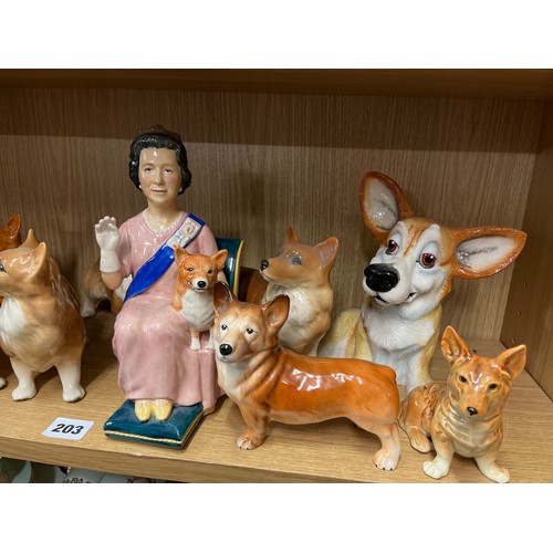 203 - SHELF OF CERAMIC CORGI DOG FIGURES INCLUDING BESWICK AND COOPER CRAFT AND A FIGURE OF HER MAJESTY TH... 