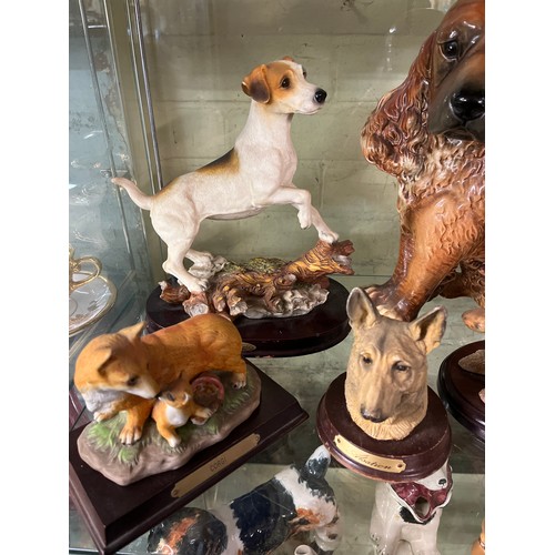 239 - TWO SHELVES OF ASSORTED DOG FIGURES INCLUDING TERRIERS TEAPOT, ALSATIAN, POODLES, ETC