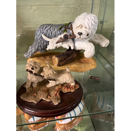 239 - TWO SHELVES OF ASSORTED DOG FIGURES INCLUDING TERRIERS TEAPOT, ALSATIAN, POODLES, ETC