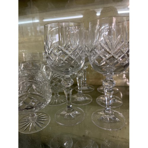 245 - TWO SHELVES OF CUT GLASSWARE INCLUDING SHERRY GLASSES, BRANDY GLASSES AND LATTICE ORNAMENTS