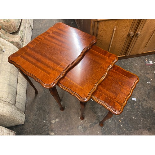 27 - MAHOGANY SERPENTINE NEST OF SPIDER LEG TABLES