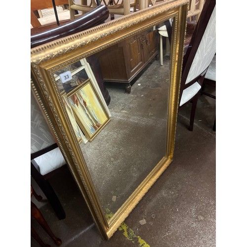 33 - GILT ORNATE FRAMED BEVELLED MIRROR