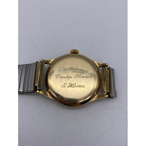 439 - GENTS 9CT GOLD GARRARD PRESENTATION WRIST WATCH ON EXPANDING STRAP AS FOUND