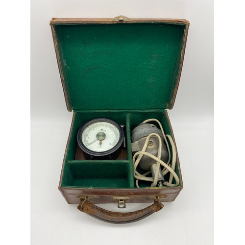 421 - THREE 500V MEGGER BAKELITE CASED METERS, TIN CASE AND LEATHER CASE CONTAINING GAUGE