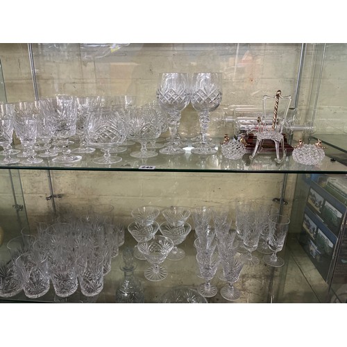 245 - TWO SHELVES OF CUT GLASSWARE INCLUDING SHERRY GLASSES, BRANDY GLASSES AND LATTICE ORNAMENTS