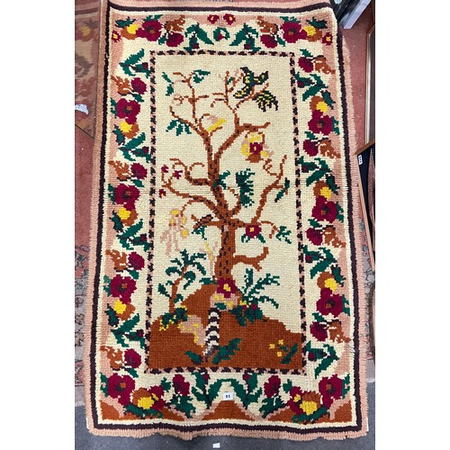 14 - MULTI COLOURED WOVEN RUG DECORATED WITH TREE DESIGN 151CM X 91CM