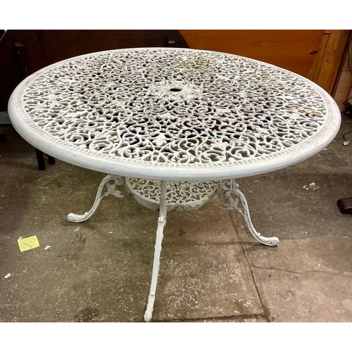 91 - VICTORIAN STYLE CAST METAL CIRCULAR PATIO TABLE AND FOUR ELBOW CHAIRS