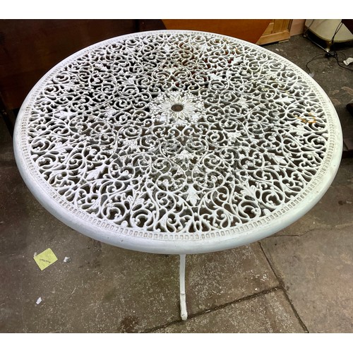 91 - VICTORIAN STYLE CAST METAL CIRCULAR PATIO TABLE AND FOUR ELBOW CHAIRS