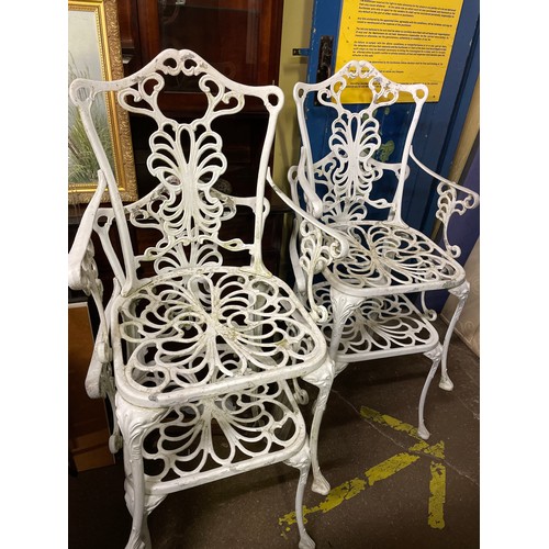 91 - VICTORIAN STYLE CAST METAL CIRCULAR PATIO TABLE AND FOUR ELBOW CHAIRS