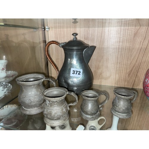 372 - SET OF ANTIQUE PEWTER GRADUATED MEASURES AND A WATER JUG