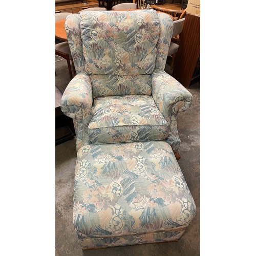 106 - FLORAL FABRIC WING ARMCHAIR ON CABRIOLE LEGS AND MATCHING FOOTSTOOL