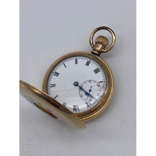 515 - GOLD PLATED CASED HALF HUNTER POCKET WATCH WITH WHITE ENAMEL DIAL AND ROMAN NUMERALS THE FRONT CASE ... 