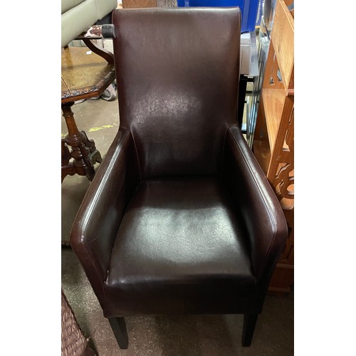 142 - A BROWN LEATHER EFFECT ARMCHAIR AND A SEAGRASS HIGH BACKED ARMCHAIR