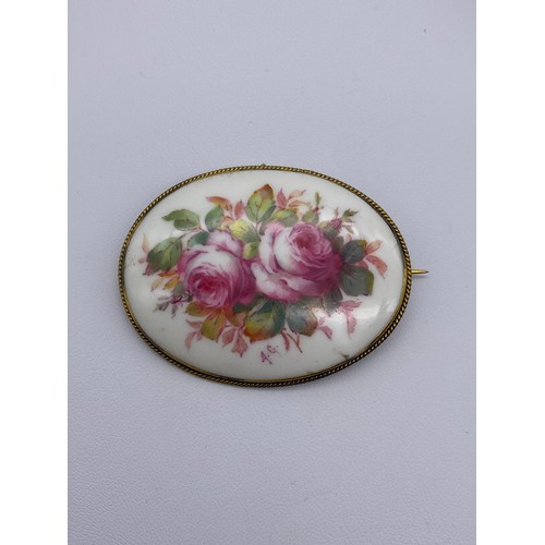 518 - TURN OF THE CENTURY OVAL PORCELAIN PLAQUE BROOCH PAINTED WITH CABBAGE ROSES MONOGRAMMED AG FOR ALBER... 