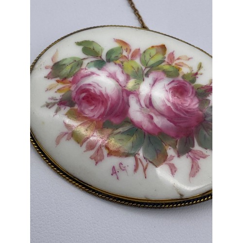 518 - TURN OF THE CENTURY OVAL PORCELAIN PLAQUE BROOCH PAINTED WITH CABBAGE ROSES MONOGRAMMED AG FOR ALBER... 