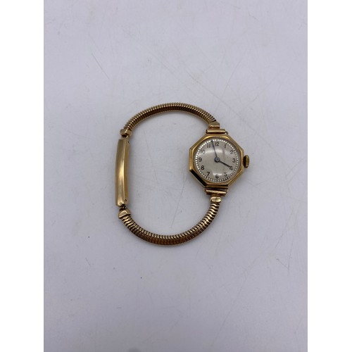 545 - 9CT GOLD OCTAGONAL CASED LADIES WRIST WATCH ON 9CT GOLD HERRINGBONE STRAP 18.3G APPROX