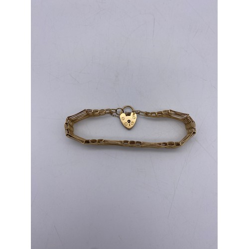 555 - LADIES 9CT GOLD SIX STRAND BRACELET WITH HEART PADLOCK AND SAFETY CHAIN 10.2G APPROX