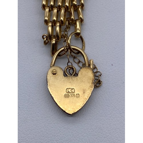 555 - LADIES 9CT GOLD SIX STRAND BRACELET WITH HEART PADLOCK AND SAFETY CHAIN 10.2G APPROX