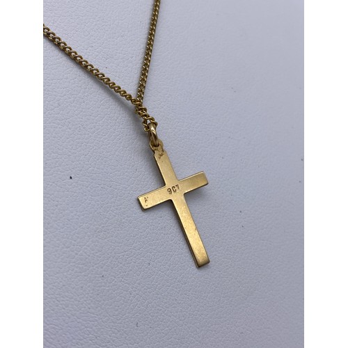 557 - 9CT GOLD CROSS ON ROLLED GOLD CHAIN, 9CT GOLD LEAPING DOLPHIN BROOCH 1.5G APPROX OVERALL