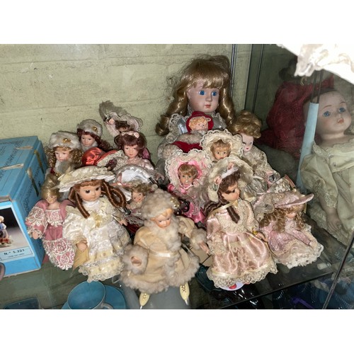 380 - SHELF AND HALF OF SMALL TO MEDIUM SIZED PORCELAIN HEADED DRESS DOLLS