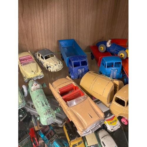 426 - TWO SHELVES OF PLAYWORN DINKY AND CORGI TOY CARS, FARM VEHICLES, AND TRUCKS