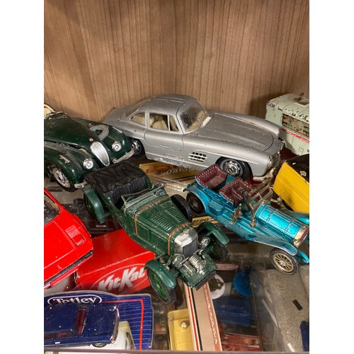 426 - TWO SHELVES OF PLAYWORN DINKY AND CORGI TOY CARS, FARM VEHICLES, AND TRUCKS