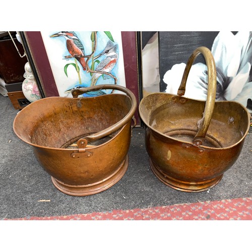 436 - TWO COPPER COAL SCUTTLES WITH SWING HANDLES AND QUANTITY OF EMBOSSED WALL PLATES AND CHARGERS